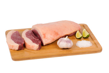 fresh and raw beef meat on cutting board on white background