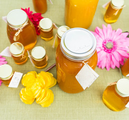 Fresh natural honey for sale from Massachusetts at the Sowa market. Flowers and honey background - obrazy, fototapety, plakaty
