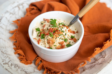 Shredded chicken in cream cheese sauce and bacon cooked in slow cooker