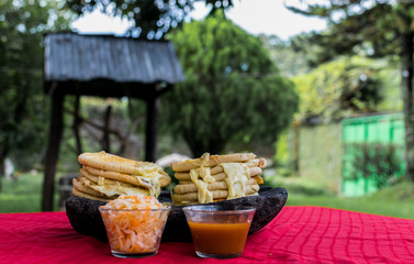 typical Salvadoran dish, cheese pupusas with cabbage and tomato sauce. rice and corn pupusas...
