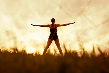 Fototapeta na wymiar Woman doing stretching exercises, and body workout outdoors. 