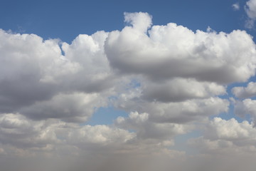 Natural colors of blue sky in the twilight. Wonderful morning landscape. Interesting backdrop from fluffy clouds in the morning sky. Scenic background in light pastel colors.