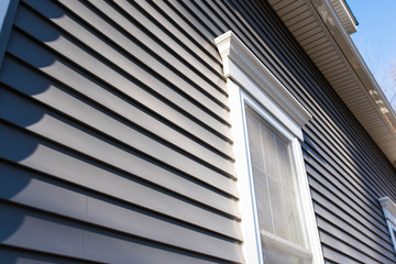 Dark vinyl siding in residential neighborhood, new window treatments - obrazy, fototapety, plakaty
