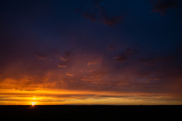 Naklejka na ściany i meble Stormy sunset in the prairies