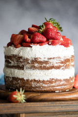 Chocolate and cream naked cake decorated with strawberries
