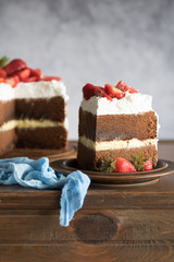 Sliced homemade chocolate naked cake with strawberries.