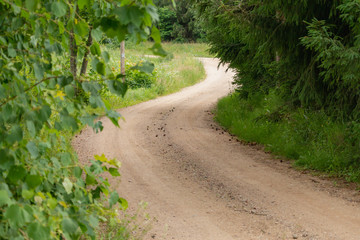 Fototapeta na wymiar Curvy gravel countryside road in the Lithuania