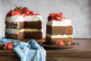 Sliced homemade chocolate naked cake with strawberries.