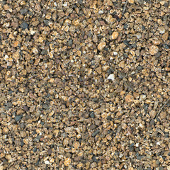 Small stones of seamless texture. Seamless surface texture covered with small dark brown stones.