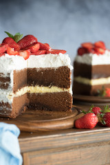 Sliced homemade chocolate naked cake with strawberries.