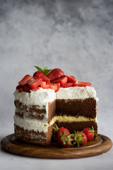 Sliced homemade chocolate naked cake with strawberries.