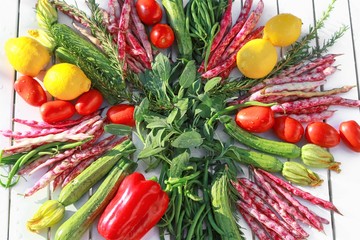 playful composition of fruits and vegetables top view with background on white table