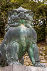 Fototapeta na wymiar Bronze lion guardian statue in Miyajima island, Japan