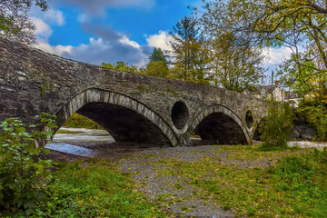 A view along the bridge over the river Teifi at Cenarth, Wales after heavy rainfall