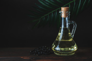 Obraz na płótnie Canvas Bottle or jar of sunflower oil on wooden table
