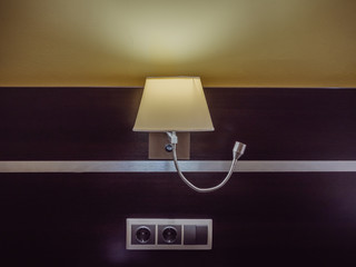 Luminous lamp hanging on the wall with wooden trim