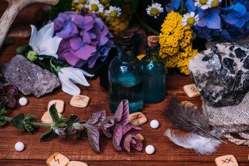 witchcraft concept with potions, herbs and occult equipment