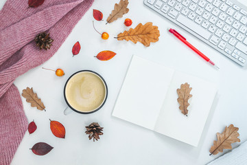 Cup of coffee, women scarf, autumn leaves on white background
