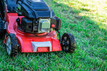lawn mower on the grass with copy space, agricultural and gardening machinery