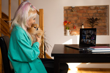 Fall at home. Day to day new normal office Work from home. Young woman having video call via laptop...