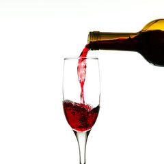 Fototapeta na wymiar wine is poured into a glass from a bottle on a white background