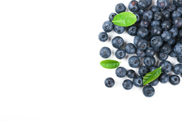 blueberry berries with green leaves on white background top view with copy space