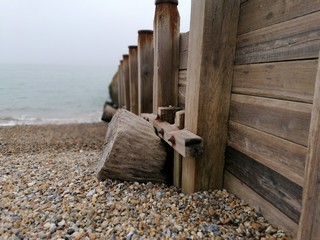 Giant wooden log defence by the sea in south Sussex.