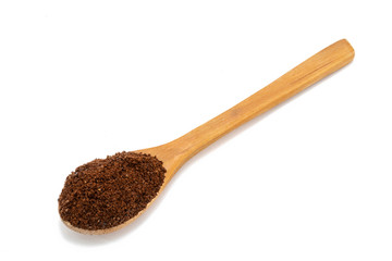 Wooden spoon with ground coffee.
