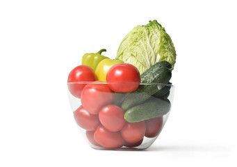 Fresh vegetables in glass bowl on white isolated background