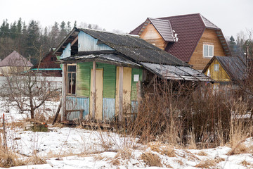 Russian village house next to a spring road