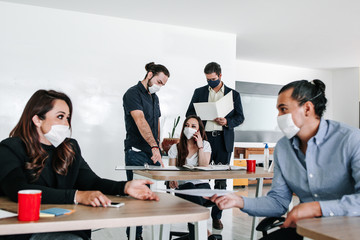 Latin mexican business teamwork with face mask, mexican people at office or workplace in Mexico pandemic
