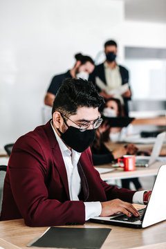 Mexican Man With Computer And Face Mask At Office Or Workplace In Mexico And Latin Teamwork