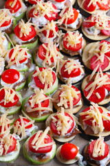 Vegetable medallions with marinated chicken fillet with cheese and garlic creamy sauce dressing are prepared for baking.
