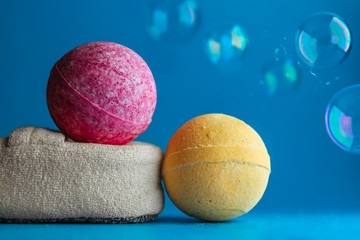 Creative photography of bath accessories. bath bombs, sponge and soap bubbles. Natural cosmetics, SPA concept. Copy space.