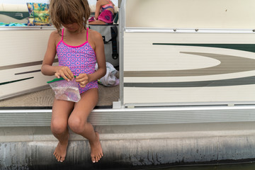 Young girl sitting on a pontoon boat