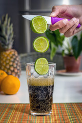 Lemons flying into a cup of cola