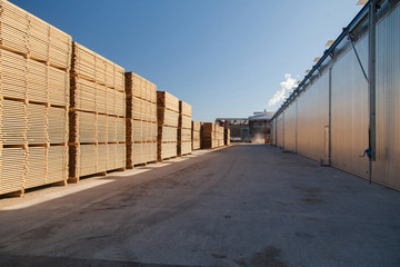 A pallet of boards in an industrial sawmill warehouse