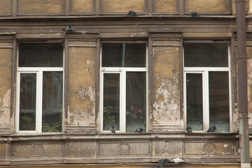 Shabby windows of old apartment buildings in St. Petersburg