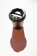 Black cup of coffee on white surface