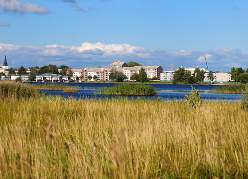 View From Grassland At Mariebergskogen To Klaralven River On A Sunny Summer Day With Some Clouds In The Sky