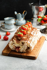 meringua roullade, roll with cream and fresh strawberries