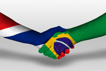 Handshake between brazil and thailand flags painted on hands, illustration with clipping path.