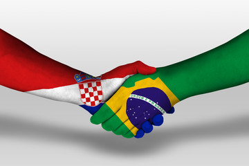 Handshake between brazil and croatia flags painted on hands, illustration with clipping path.