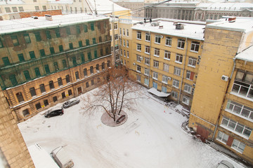 The courtyard of an old Soviet factory covered with snow
