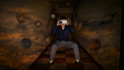 Obraz na płótnie Canvas The double exposure of an Asian man wearing virtual reality depicts a view of a building above the stars with a background.The accompanying stars of this image are decorated with images taken from NAS