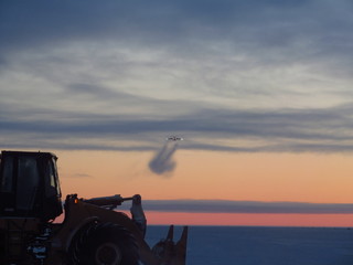 Fototapeta premium Cargo Aircraft, C-17, Approach for Landing in Polar Region, with heavy equipment, front end loader, near McMurdo Station, Antarctica