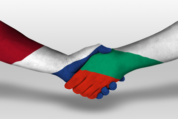 Handshake between bulgaria and netherlands flags painted on hands, illustration with clipping path.