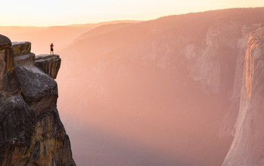 El Capitan Taft Point Yosemite National Park California male hiker stands at cliff edge 