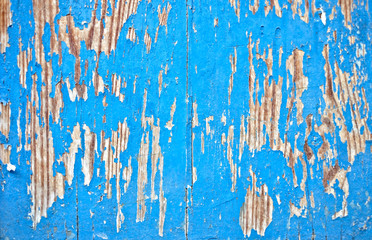 Light blue wether paint on an aged timber background.