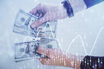 Multi exposure of financial graph drawing hologram and USA dollars bills and man hands. Analysis concept.